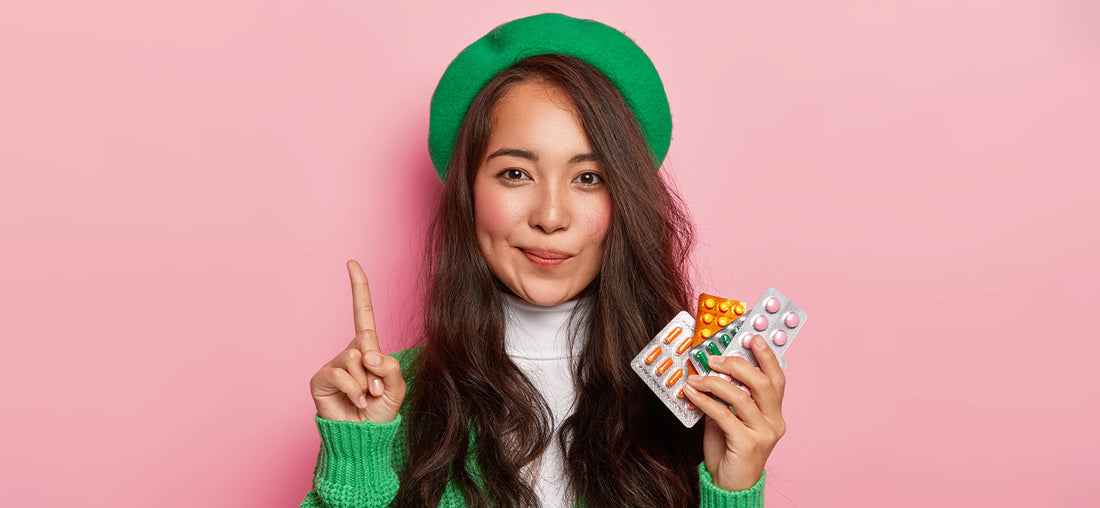 Woman holding multiple women's multivitamins trying to decide which to take based on the multivitamin tablets benefits